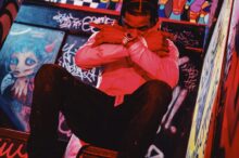 man in pink dress shirt and black pants sitting on red chair