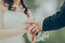 woman giving wedding ring to man