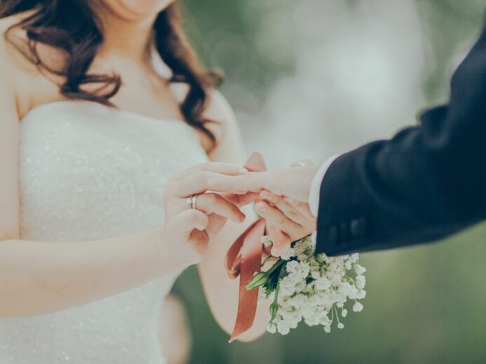 woman giving wedding ring to man
