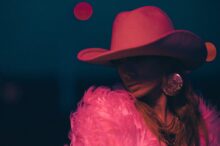 woman wearing pink cowboy hat