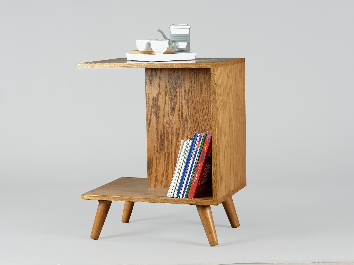brown wooden table with books and mugs