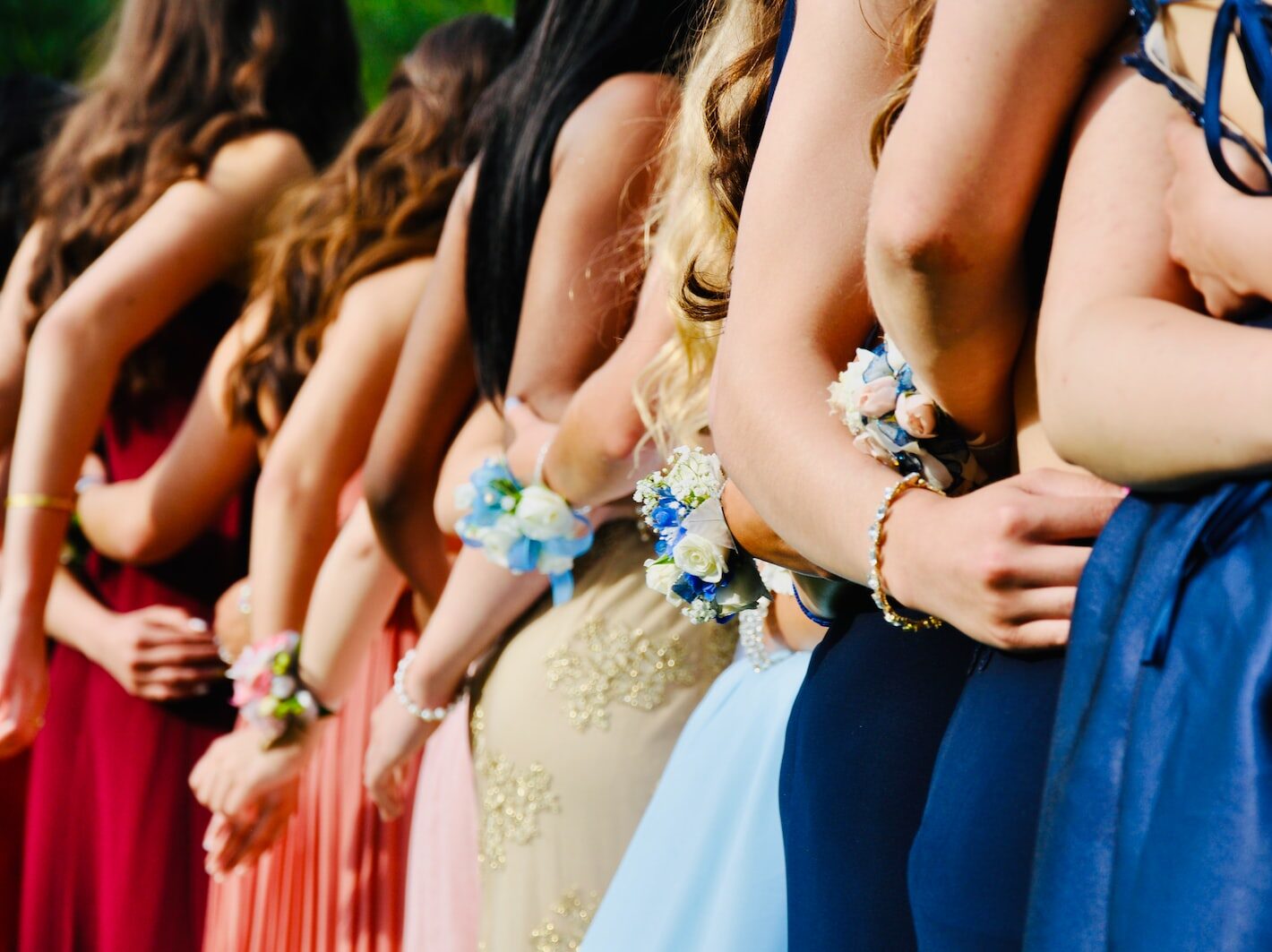 woman in blue sleeveless dress wearing blue and white floral tiara