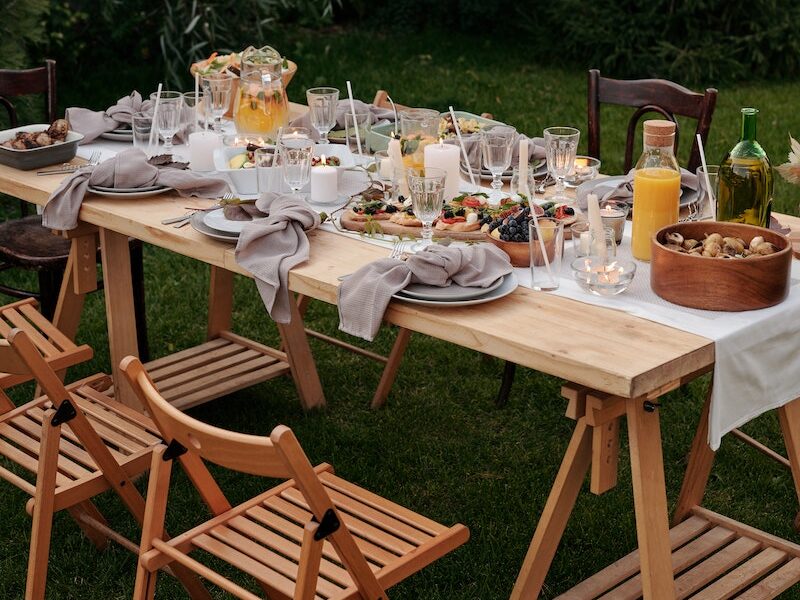 Food on Brown Wooden Table With Chairs and Plates