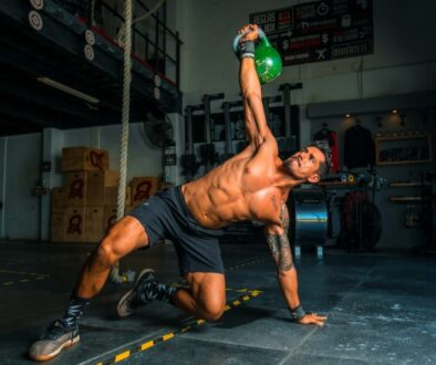 Alonso Reyes man in black shorts and black tank top doing push up