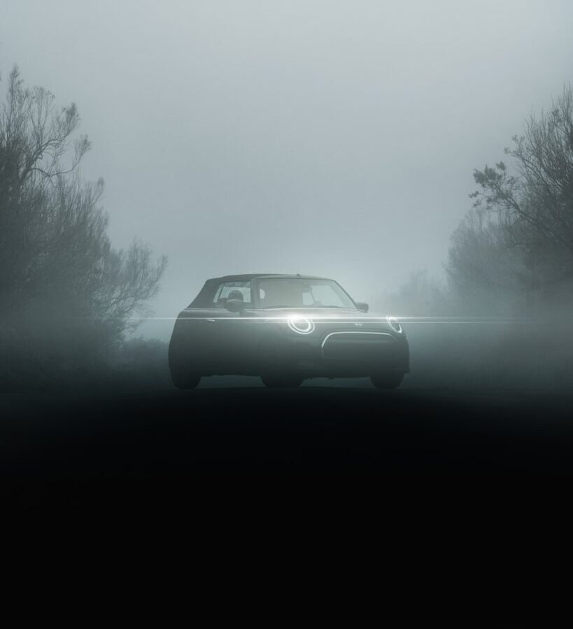 A car driving on a foggy road