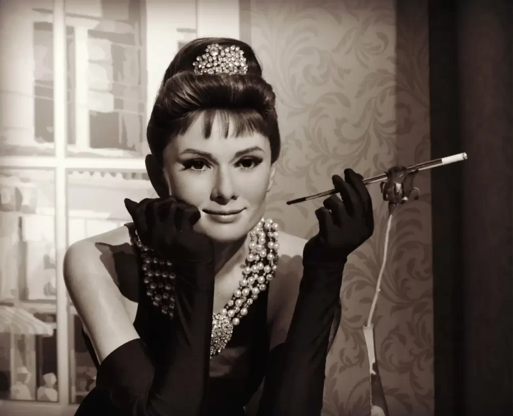 Audrey Hepburn v ikonických černých šatech, s perlovým náhrdelníkem