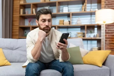 Muž kouká do telefonu