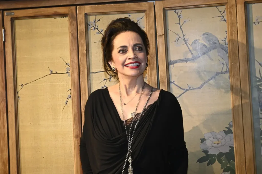 Lucie Bílá v elegantních černých šatech se šperky a výrazným červeným rtěnkou.