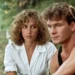 Man in a black sleeveless shirt and a white-blouse woman sit together on a park path, looking thoughtful.