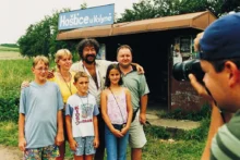 Fotograf fotí skupinu lidí na nádraží