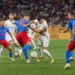 Hráči fotbalu na fotbalovém hřišti uprostřed zápasu
