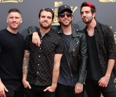 Skupina čtyř vysmátých mužů před stěnou s nápisy MTV