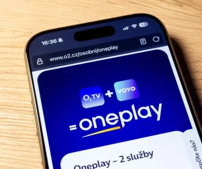 Na hnědém stole leží mobilní telefon s logem streamovací platformy